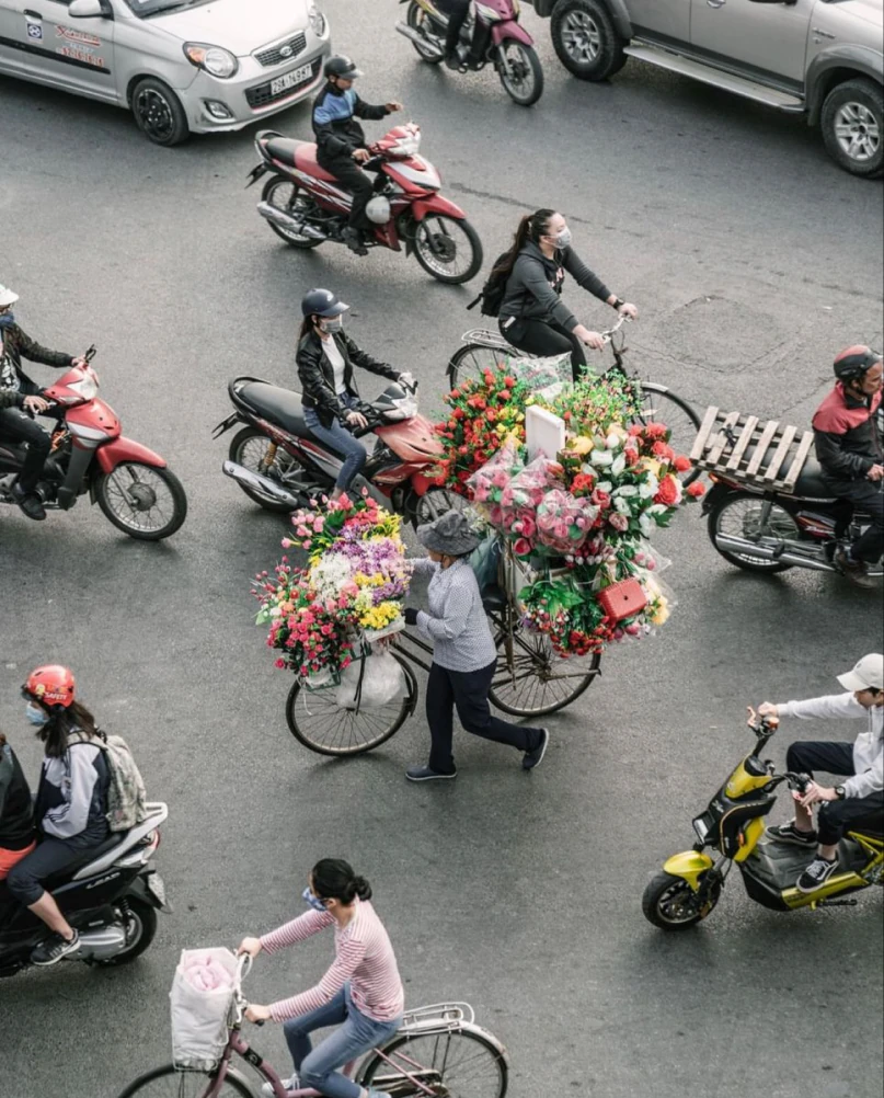 Flower sellers and commuters on a Ho Chi Minh City street